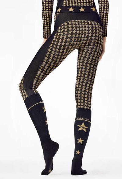 BGoldbergh lack and gold star ski socks on a woman skier Black and gold patterned leggings with star designs on a white background
